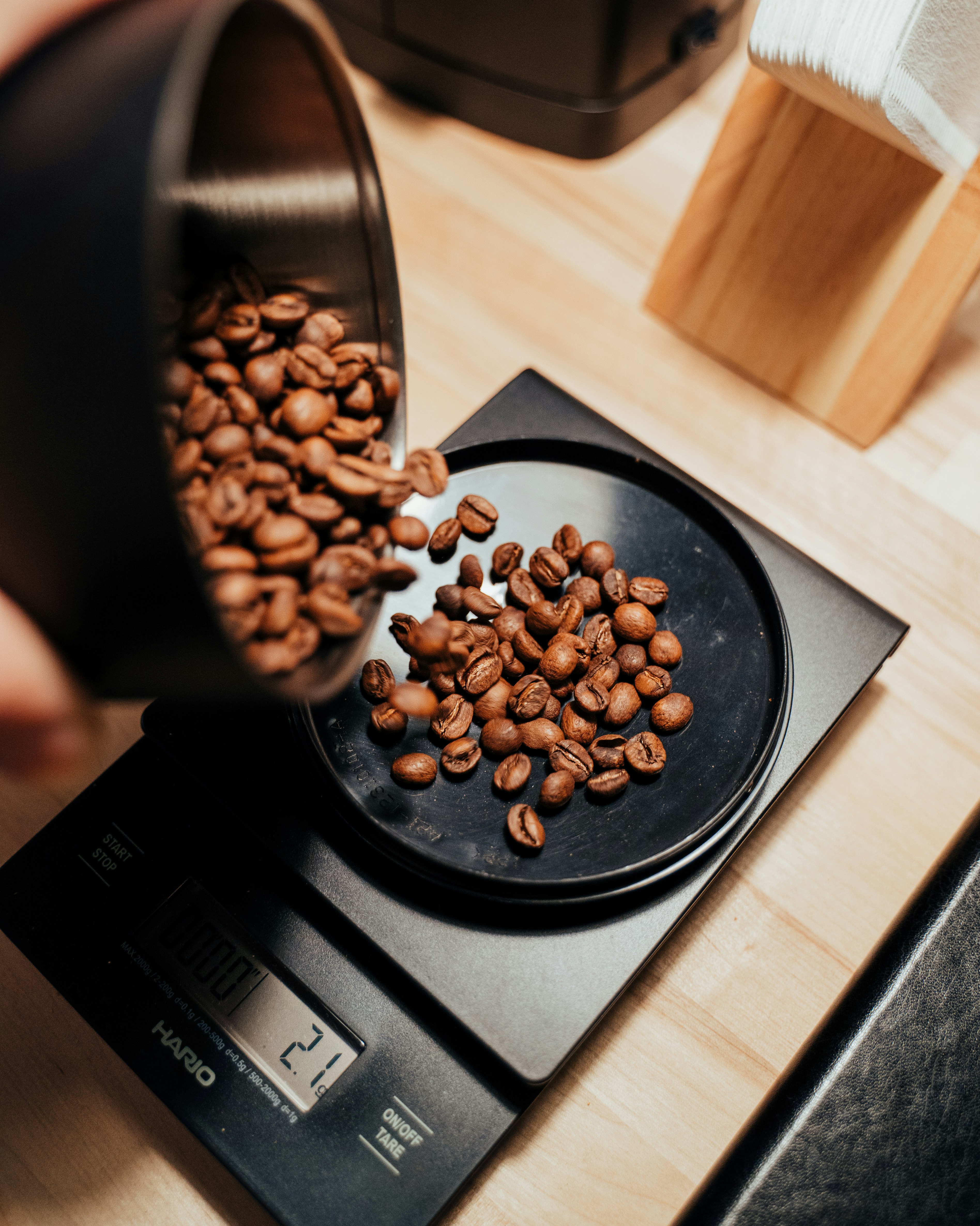 brown coffee beans on black ceramic mug